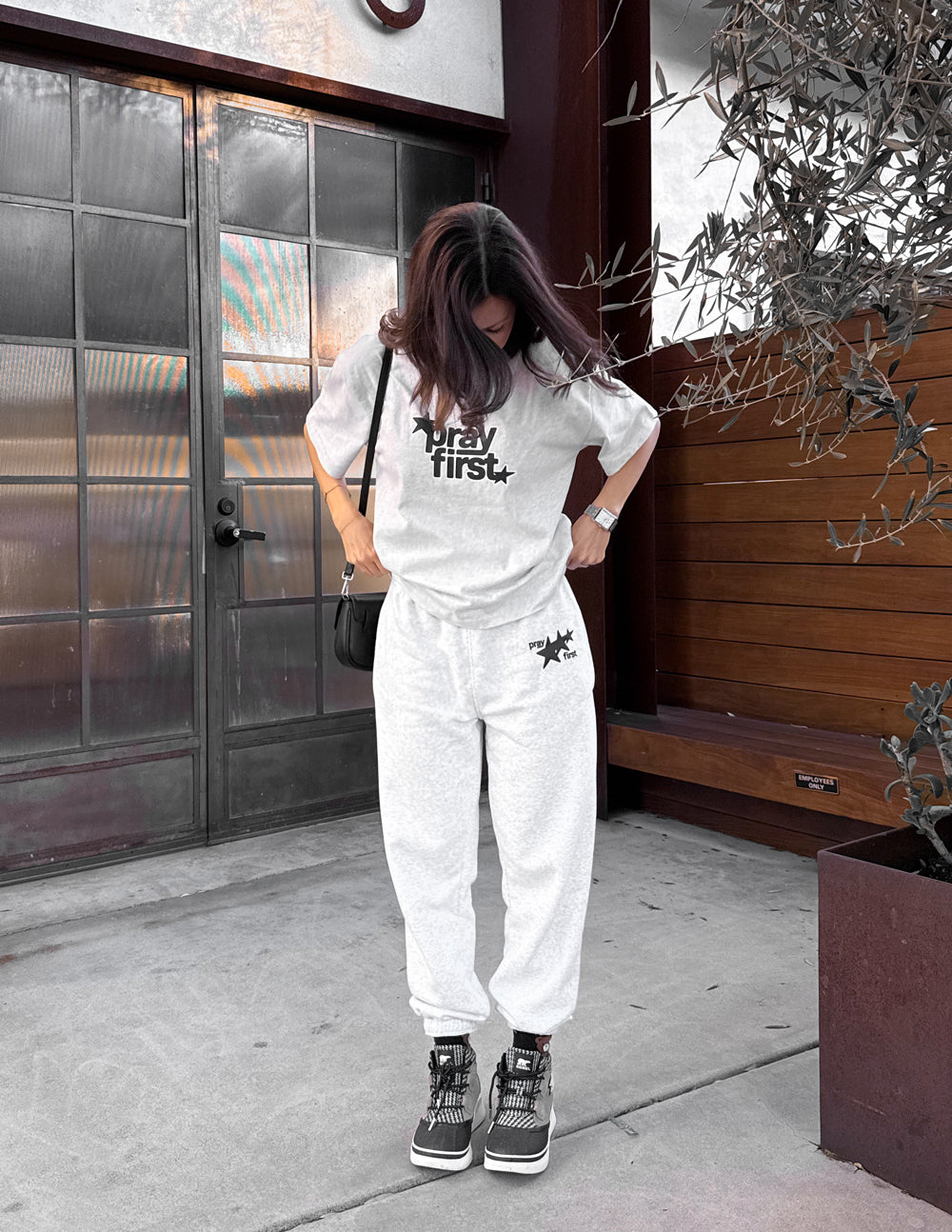 White heavyweight crewneck T-shirt with black “pray first” star graphic on chest
