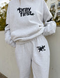 Unisex light gray sweatpants with star 'pray first' logo on thigh