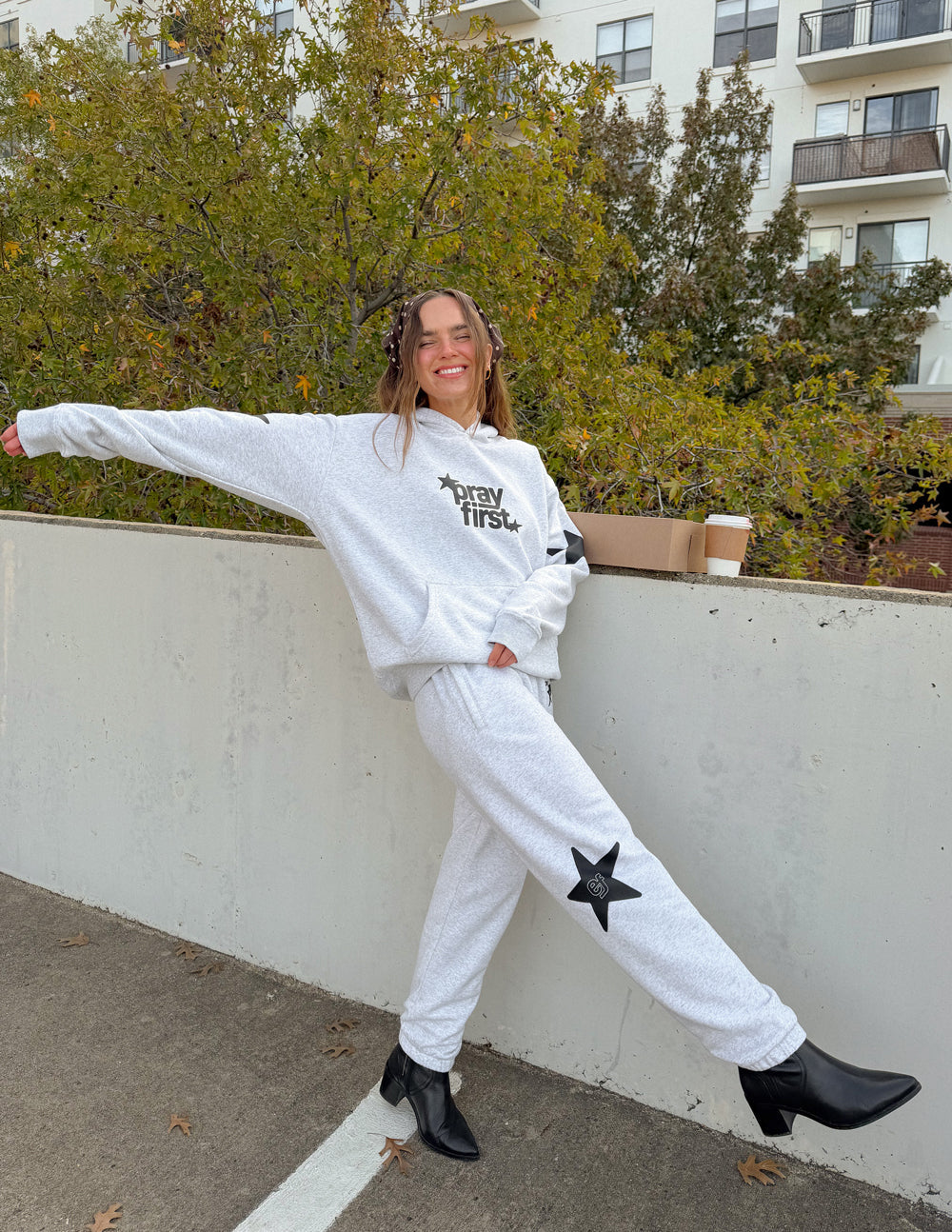 Unisex light gray sweatpants with star logo on calf, relaxed jogger cuffs