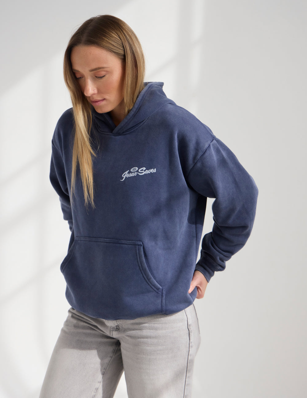 Dark navy unisex hoodie with hood and front pocket, “Jesus Saves” logo