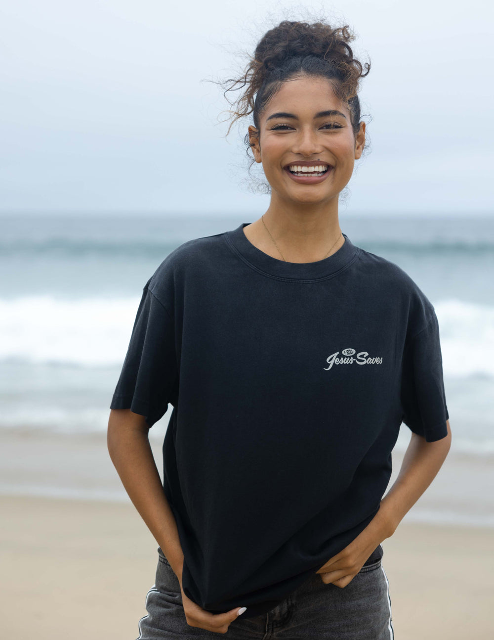 Black unisex T-shirt with small chest 'Jesus Saves' script logo