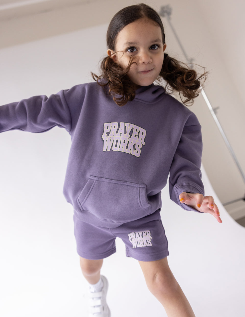 Purple kids hoodie with front pocket and Prayer Works chest graphic