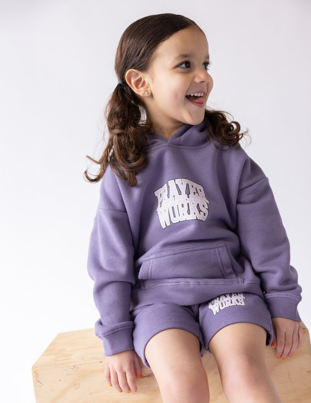 Purple kids hoodie with Prayer Works logo and kangaroo pocket