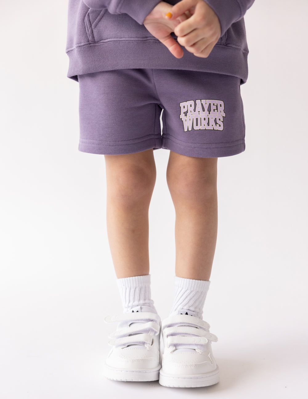 Kids purple short with PRAYER WORKS logo on front leg hem