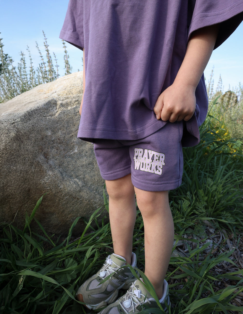 Kids purple shorts with PRAYER WORKS logo on side