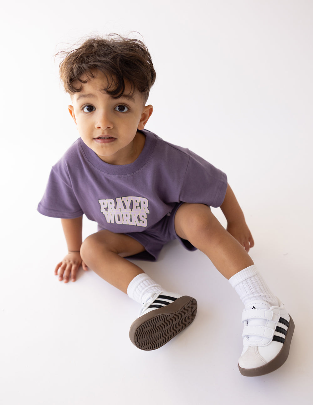 Kids purple T-shirt with 'PRAYER WORKS' graphic on chest, short sleeves