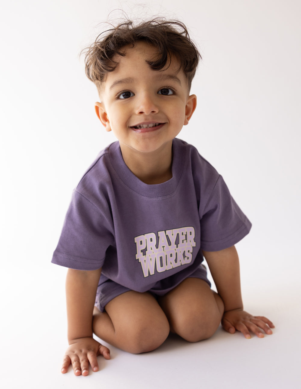Kids purple T-shirt with 'PRAYER WORKS' chest print, short sleeves