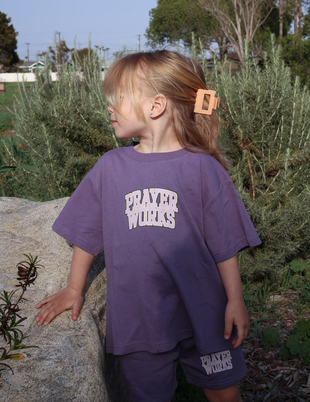 Kids purple T-shirt with 'PRAYER WORKS' logo print on back