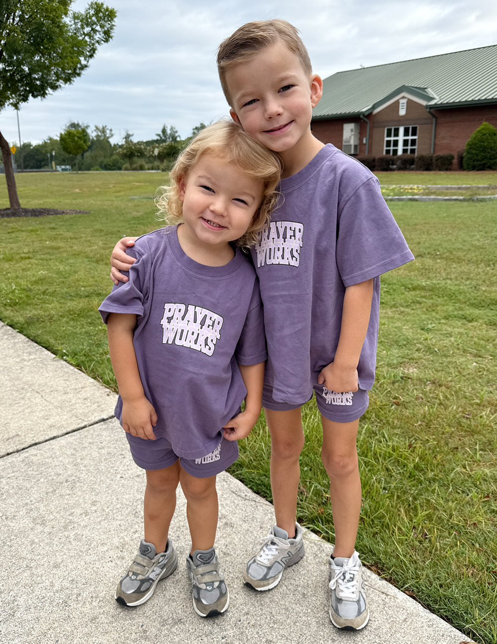 Kids purple T-shirt with 'PRAYER WORKS' graphic, crew neck and short sleeves
