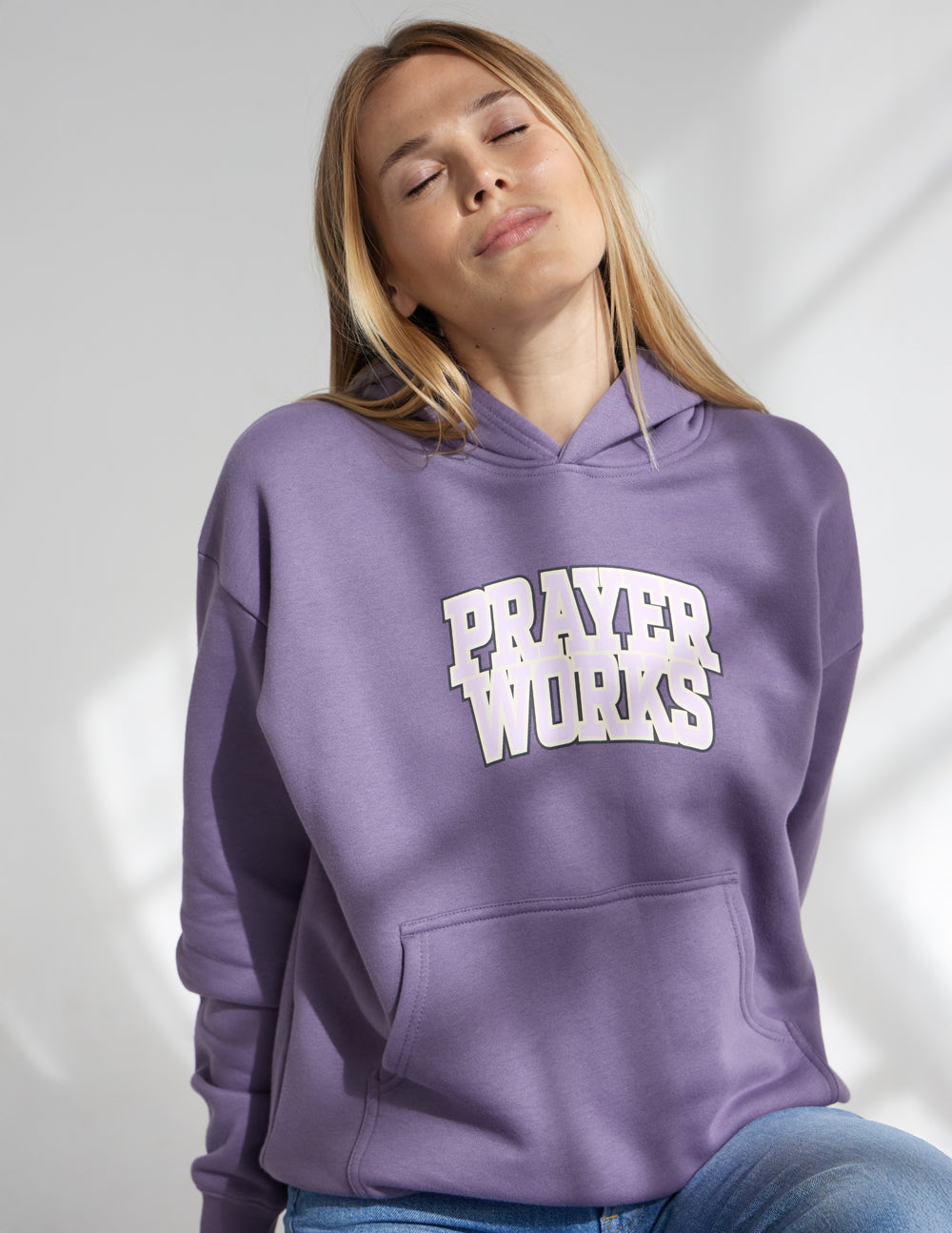 Lavender unisex hoodie with "Prayer Works" logo on the chest