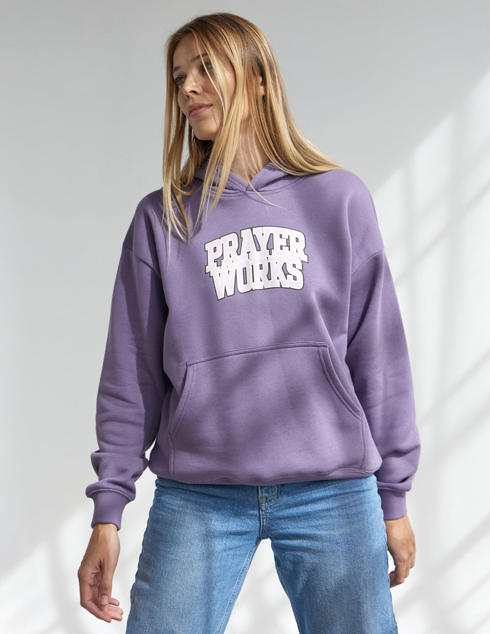 Lavender unisex hoodie with front pocket and "Prayer Works" logo graphic
