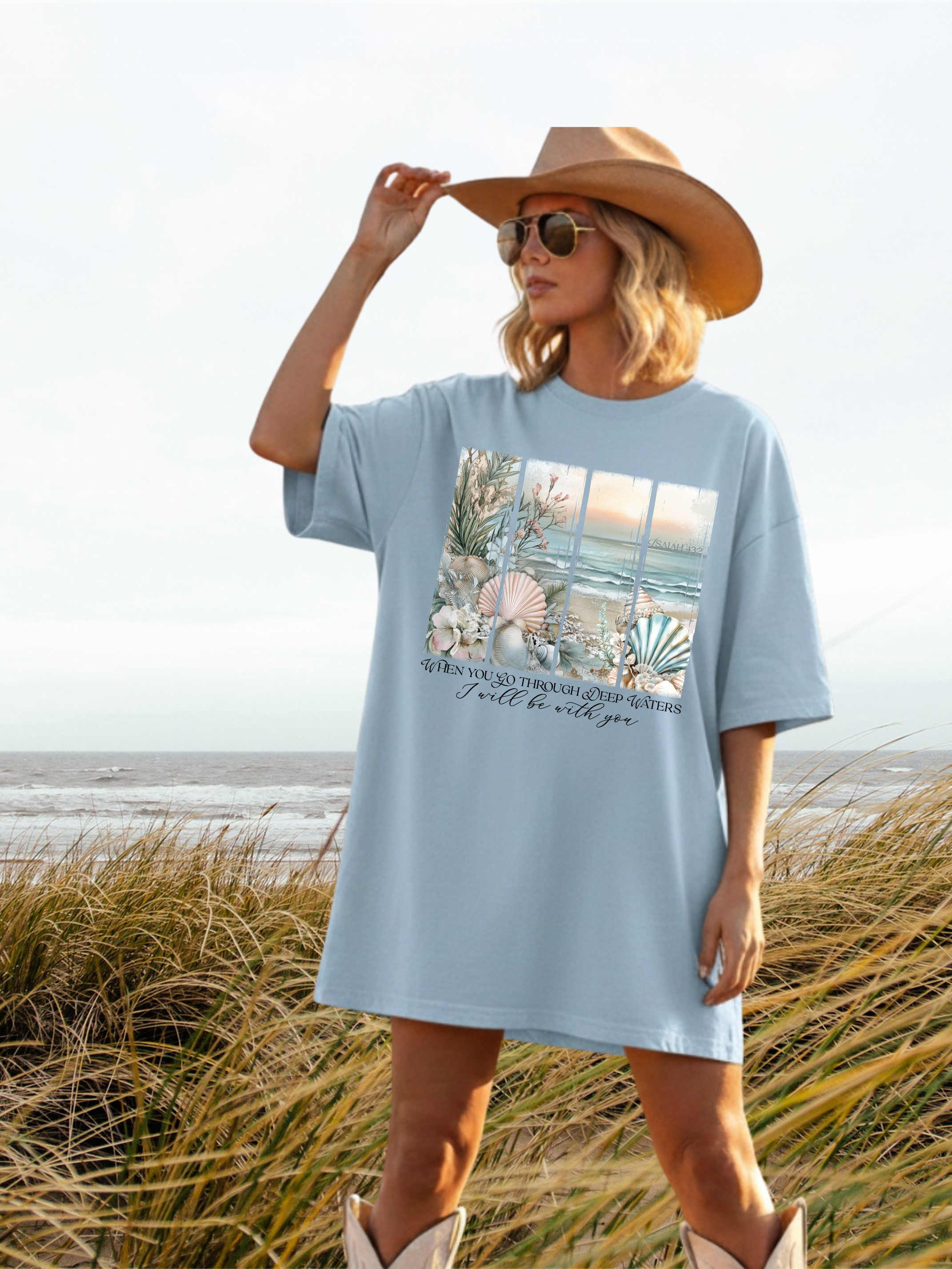 Light blue graphic T-shirt with large beach scene and text on front