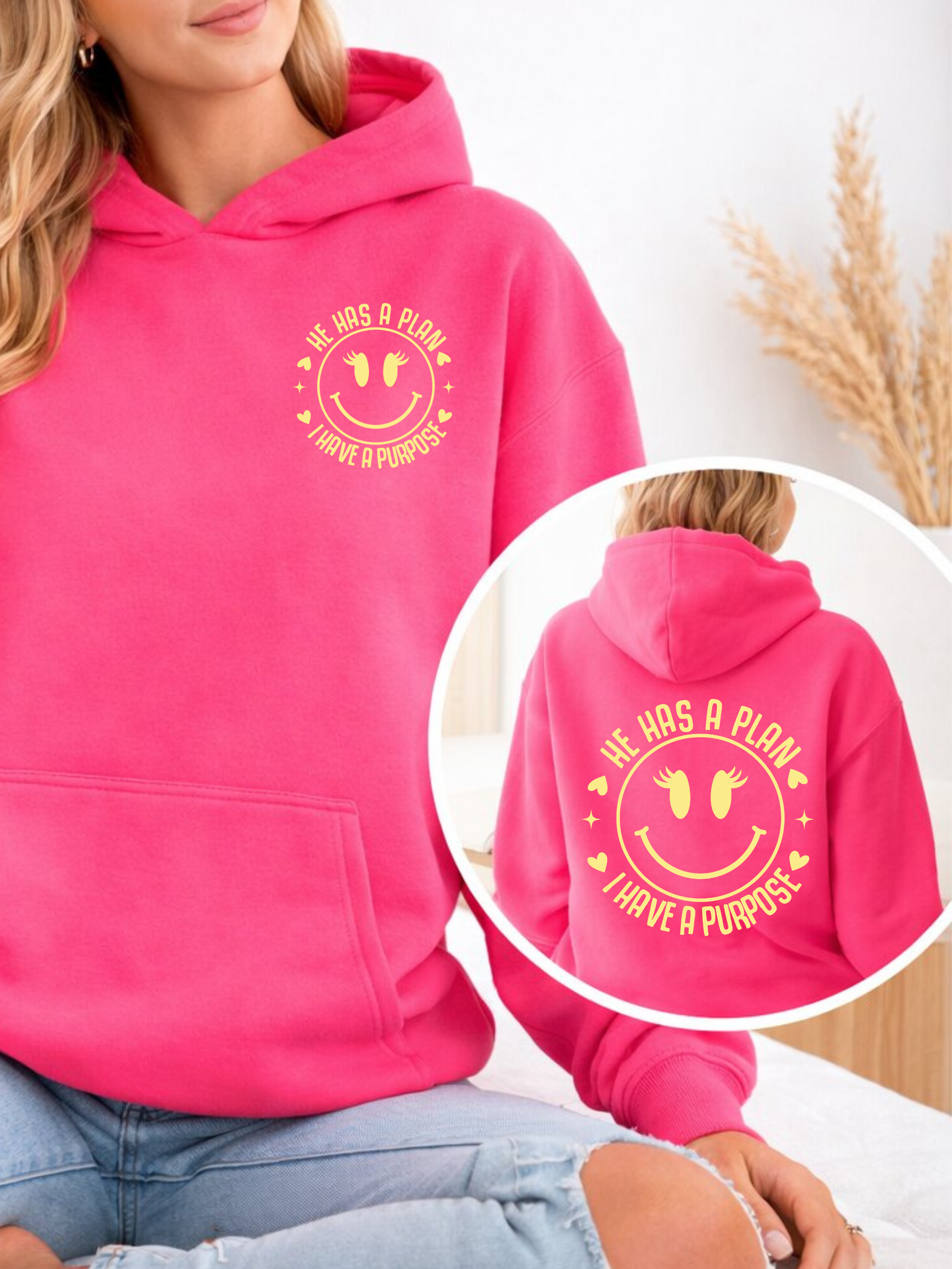 Pink hoodie with hood, front pocket, and circular 'plan/purpose' graphic on back