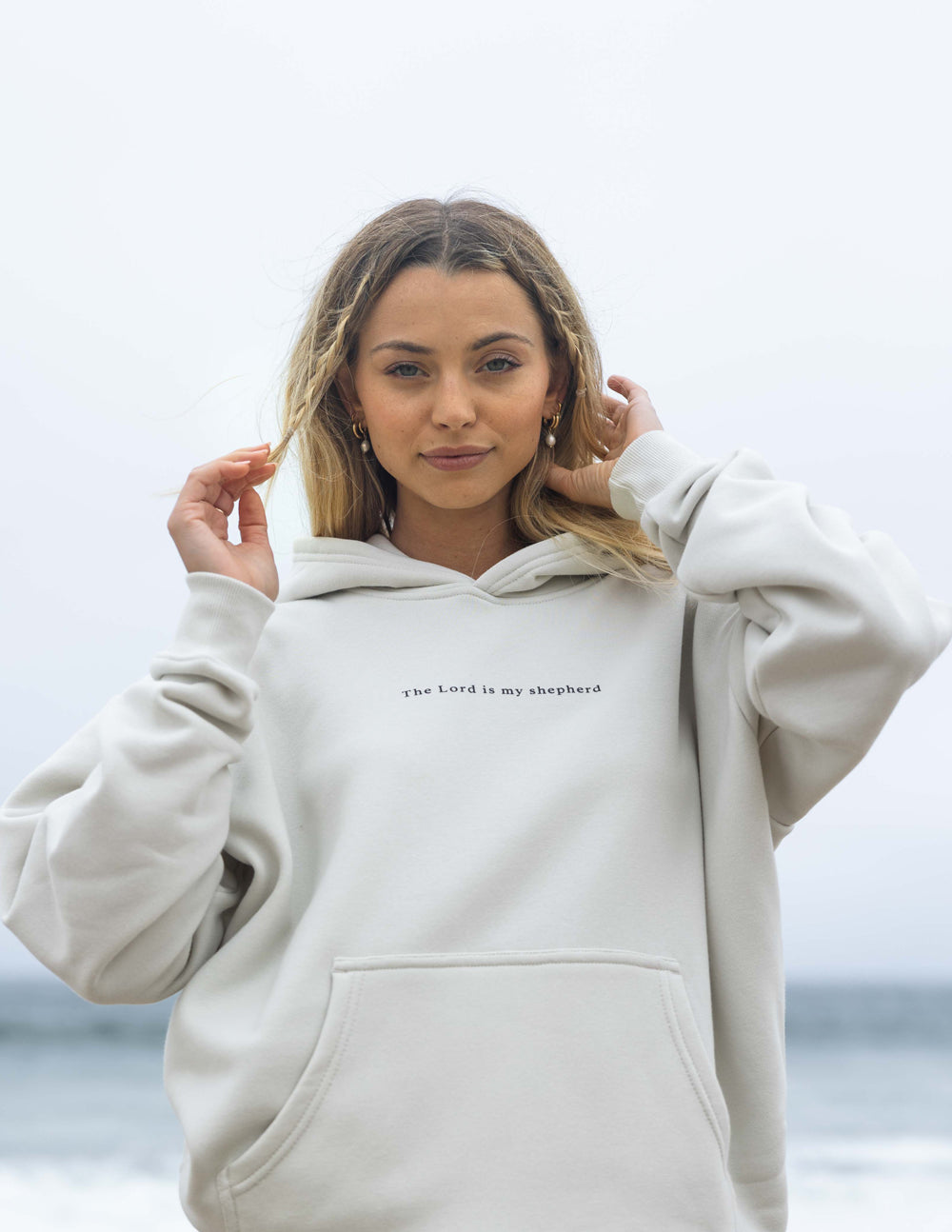 Off-white unisex hoodie with hood, kangaroo pocket, small chest text