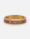 Mauve enamel wonder ring with gold-tone bezel and 'WONDER' engraving