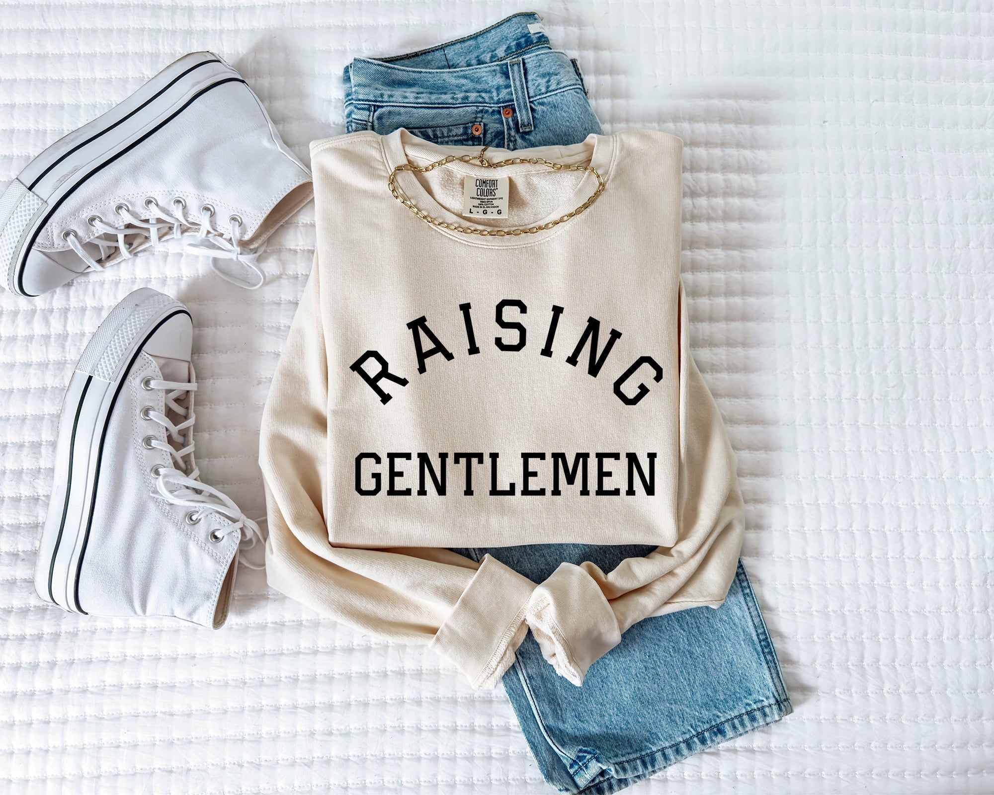 Cream crewneck sweatshirt with "RAISING GENTLEMEN" text print