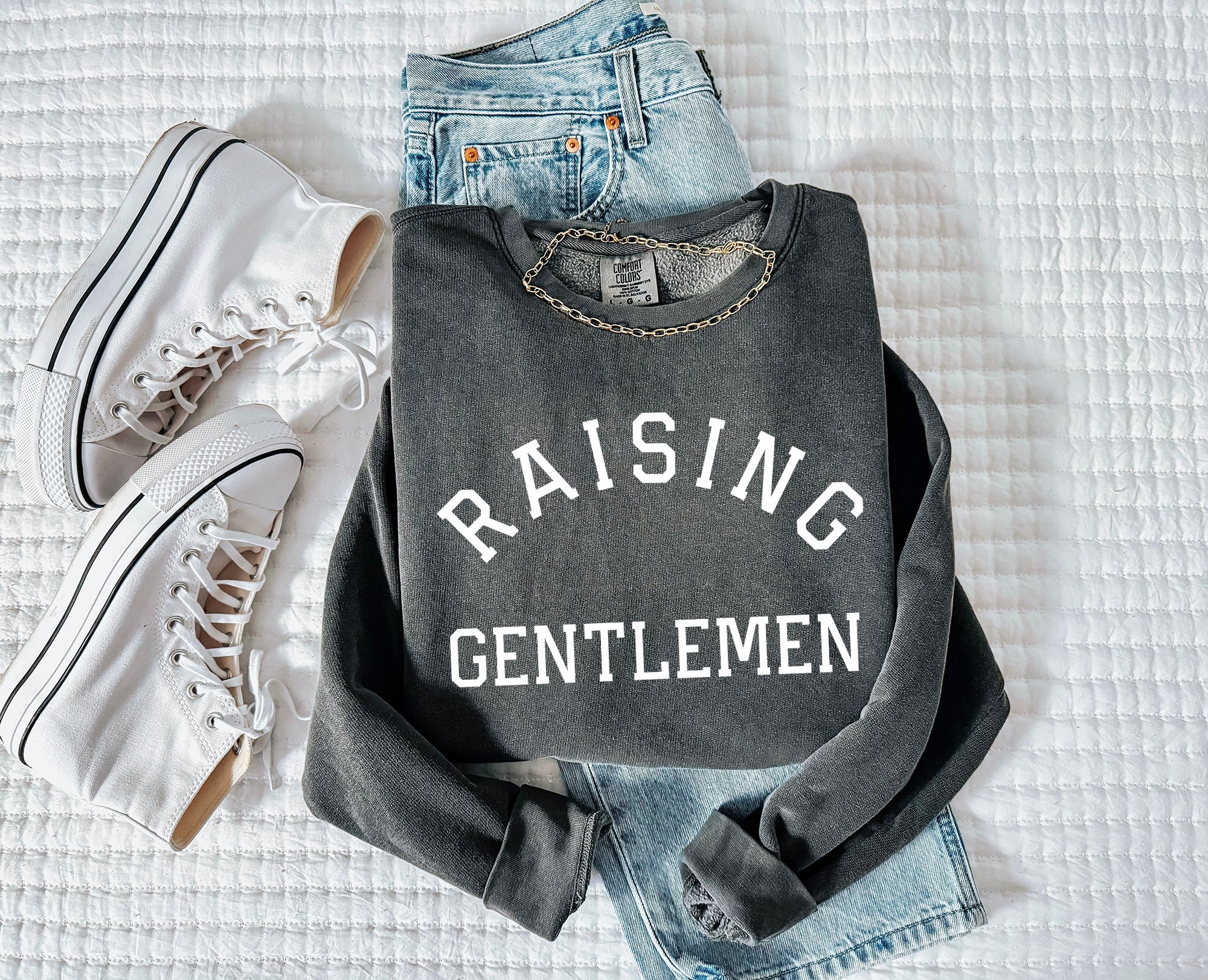 Dark gray crewneck sweatshirt with "RAISING GENTLEMEN" text print