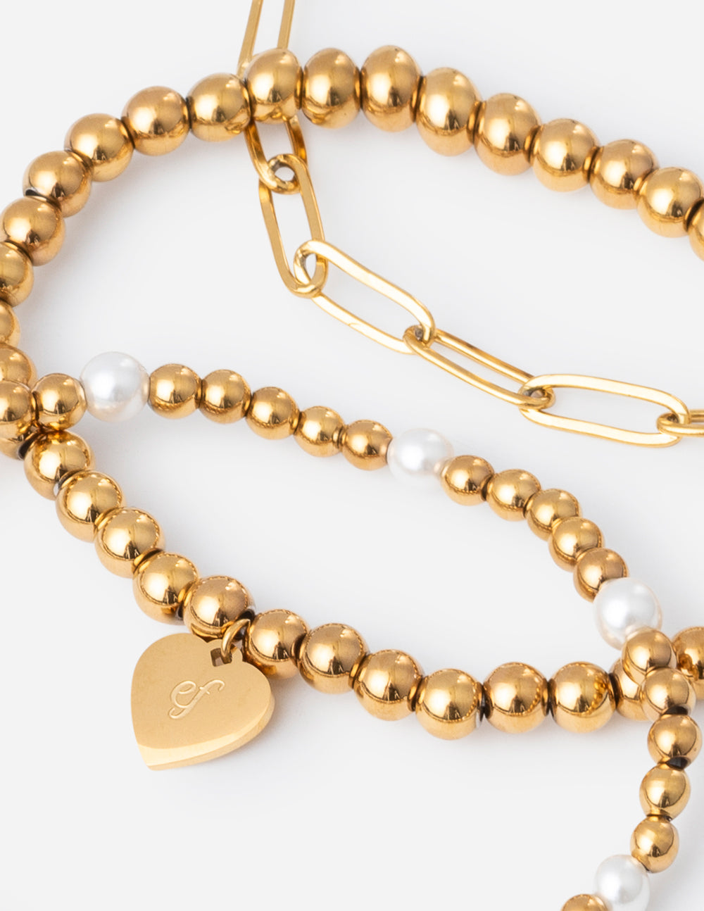 Gold-tone beaded bracelets with white pearl beads and heart tag charm