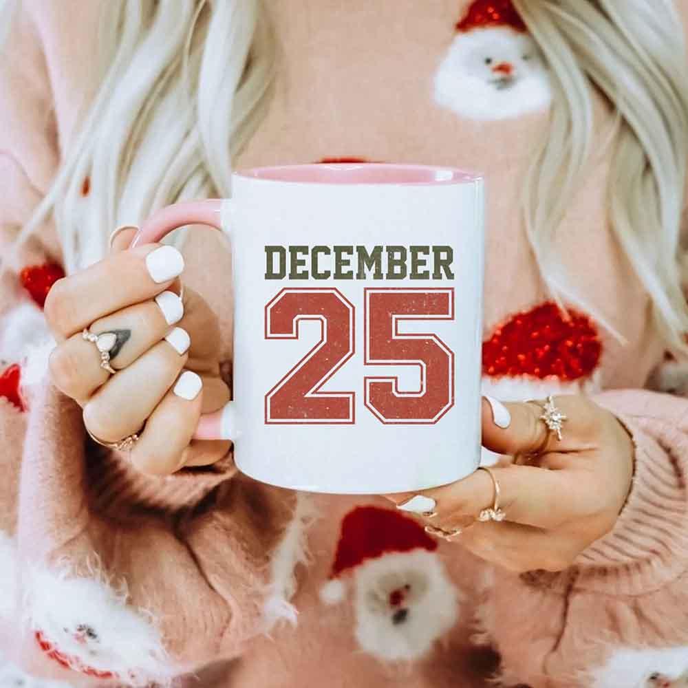 White coffee mug with 'DECEMBER 25' graphic on the front.