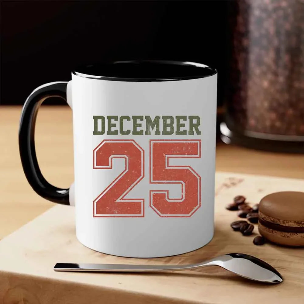 White coffee mug with black handle and rim, 'DECEMBER 25' print.