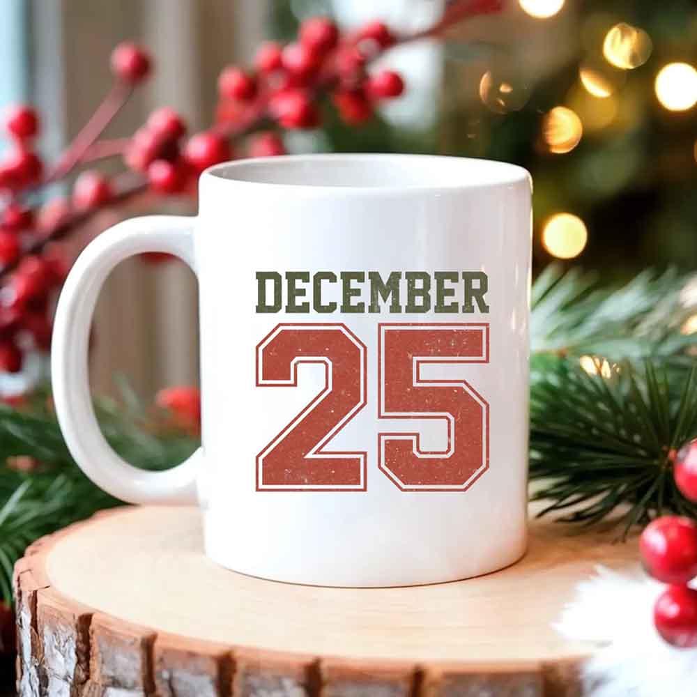 White coffee mug with 'DECEMBER 25' graphic, curved handle on left.
