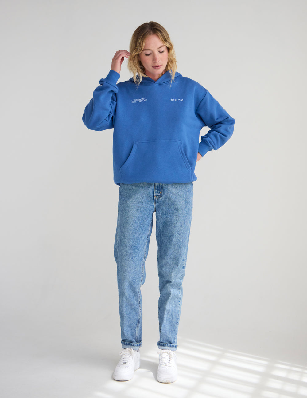 Blue unisex pullover hoodie with hood, front pocket, and chest logo.