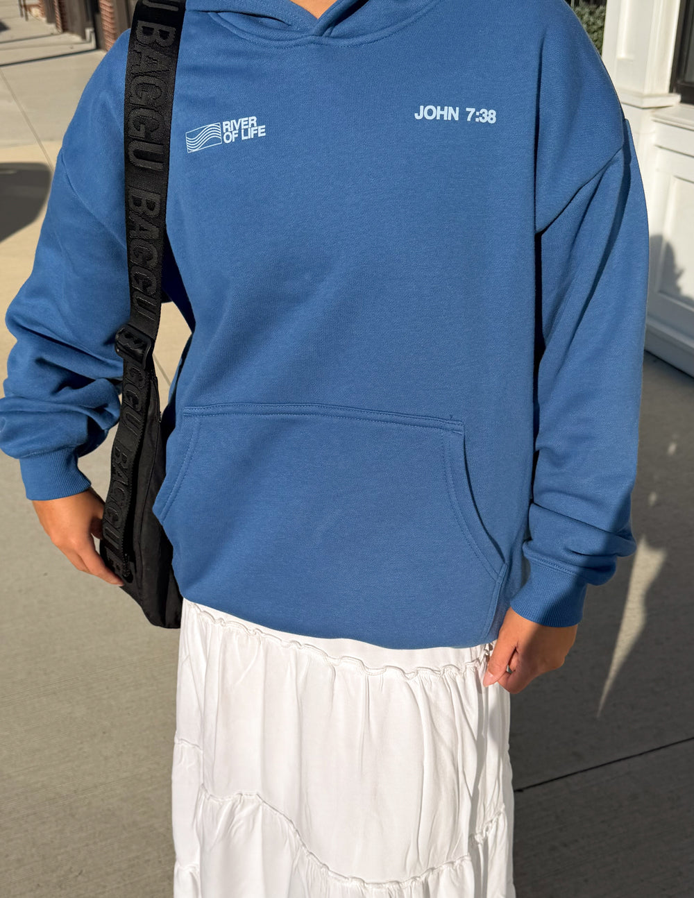Blue hoodie front close-up with hood, kangaroo pocket, and “JOHN 7:38” logo.