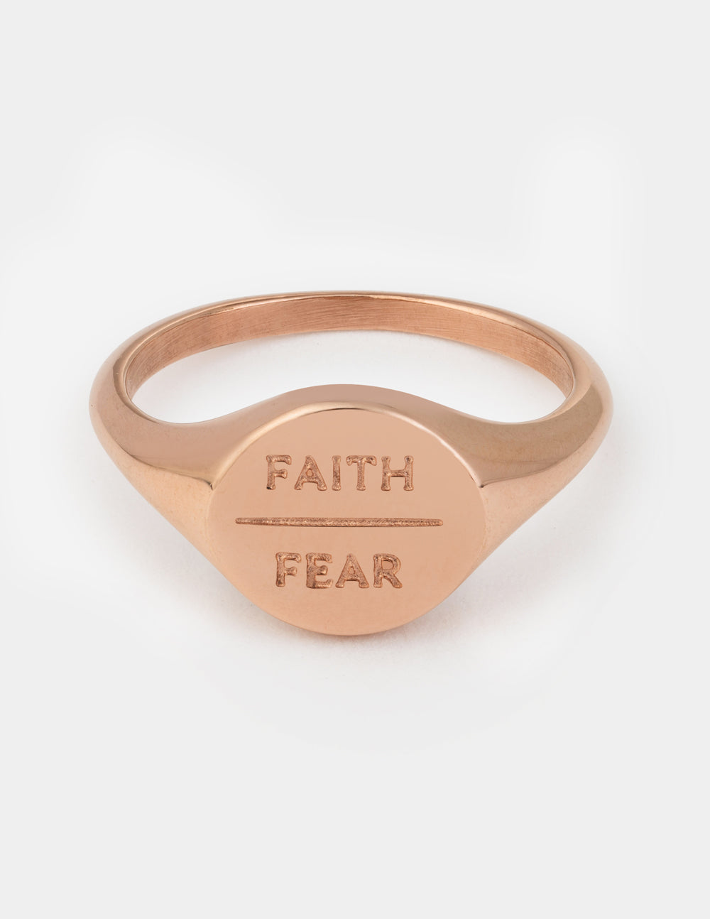 Rose gold signet ring with 'FAITH' and 'FEAR' engraved on face