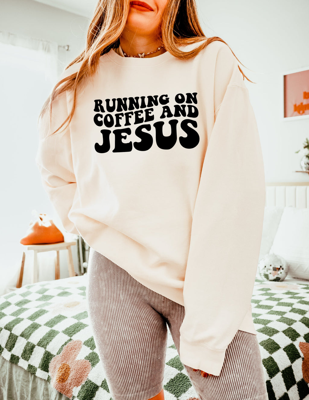 Off-white sweatshirt with bold "RUNNING ON COFFEE AND JESUS" text front.