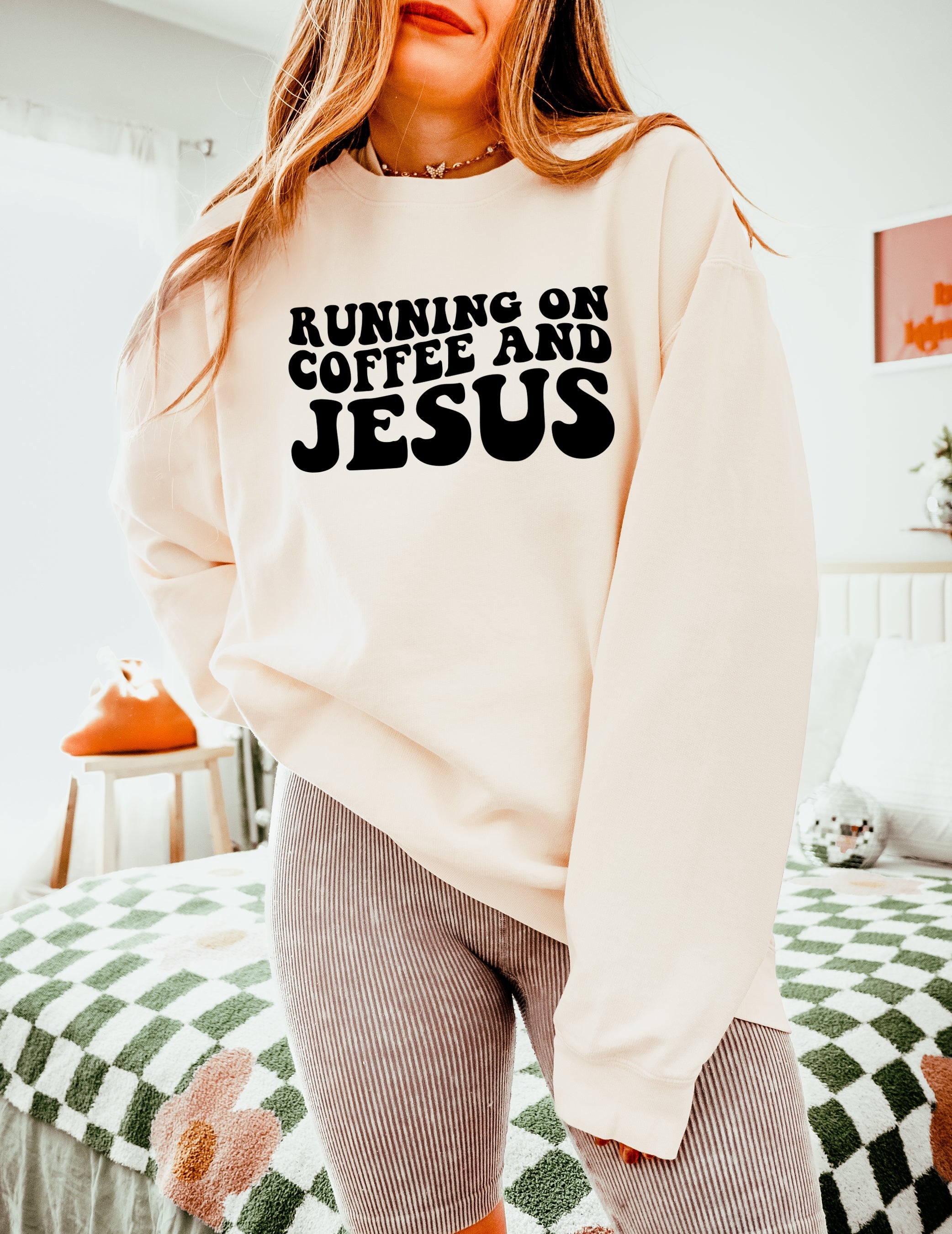 Off-white sweatshirt with bold "RUNNING ON COFFEE AND JESUS" text front.