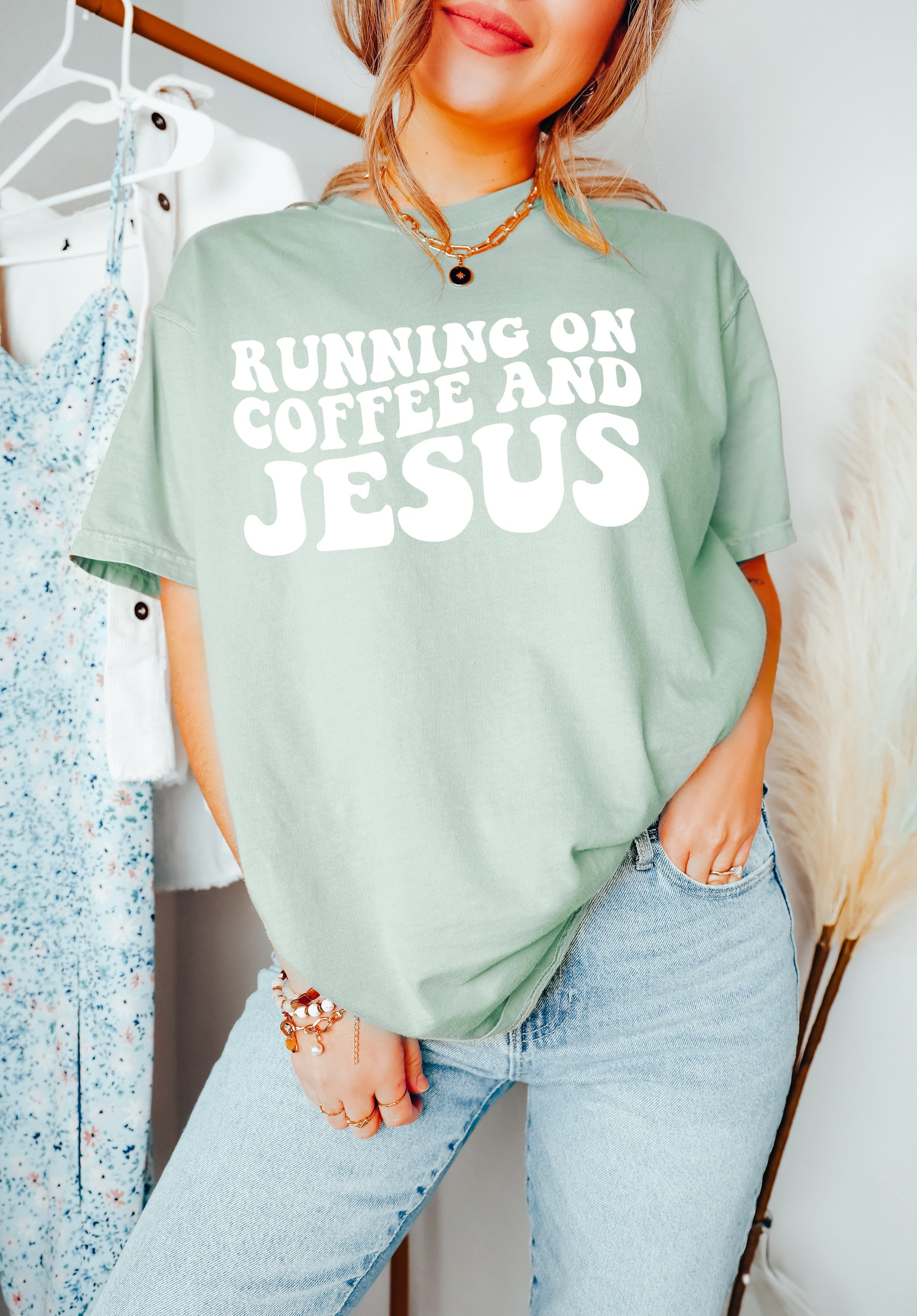 Light green graphic T-shirt with white RUNNING ON COFFEE AND JESUS lettering