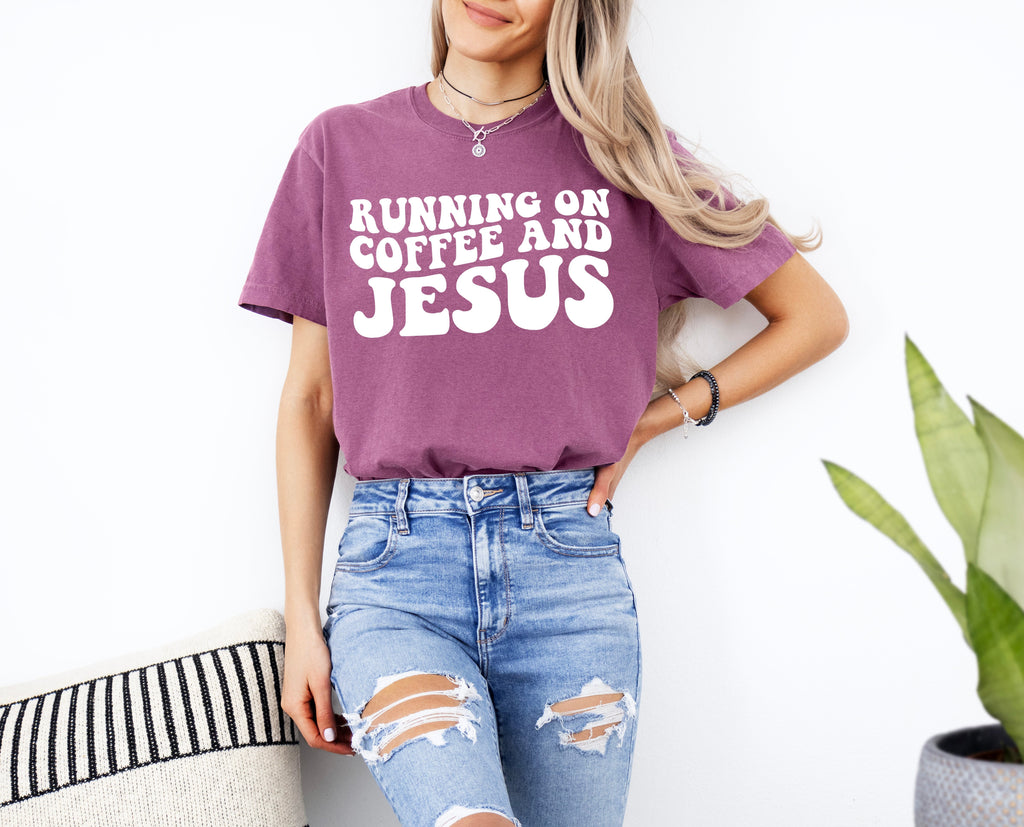 Purple graphic T-shirt with RUNNING ON COFFEE AND JESUS lettering