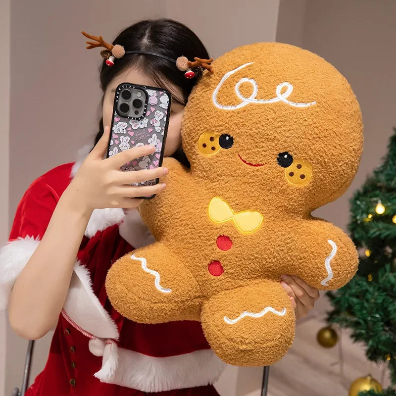 Gingerbread plush toy with smiling face and bow, close-up