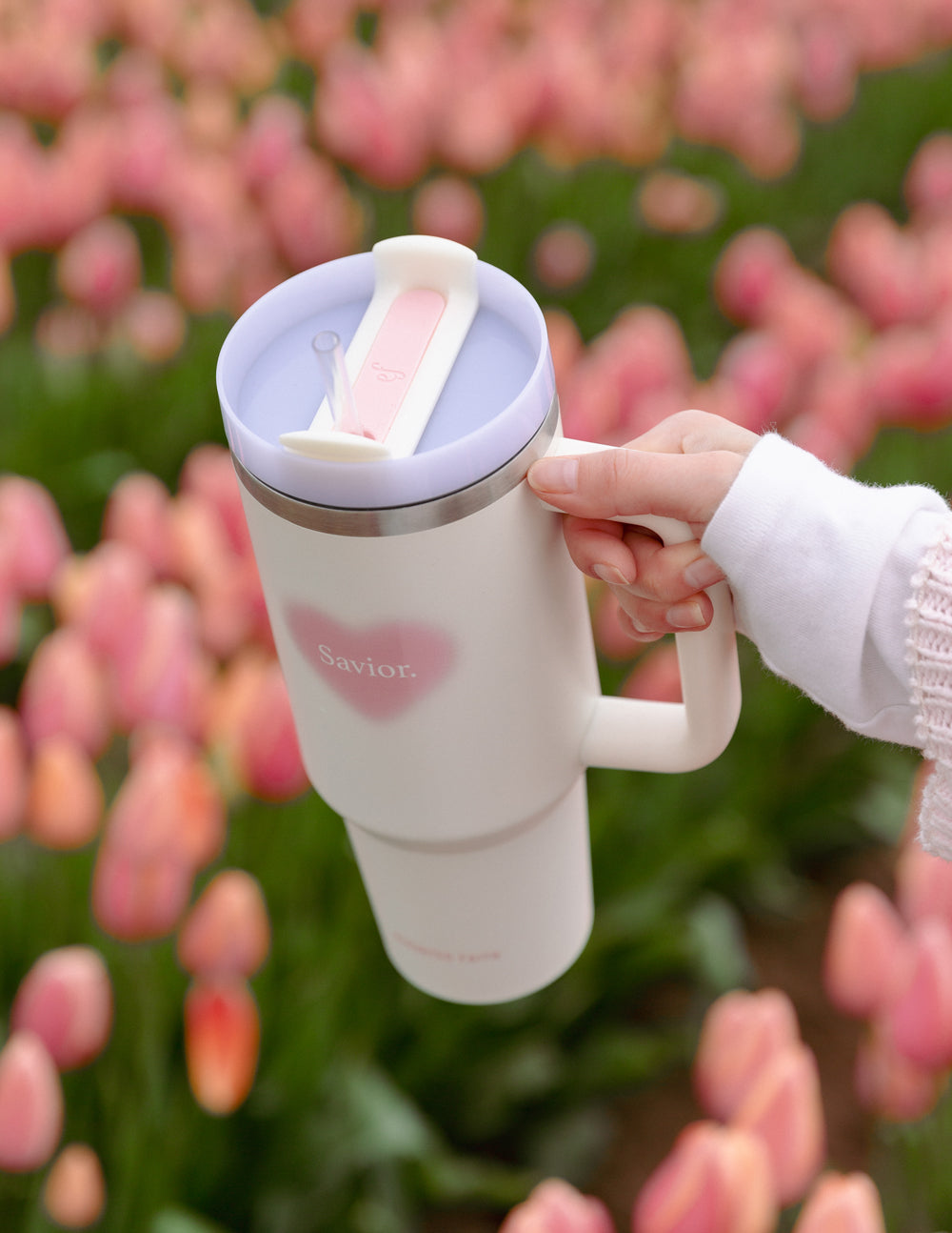 White 40 oz tumbler with pink heart logo, visible lid and straw, side handle