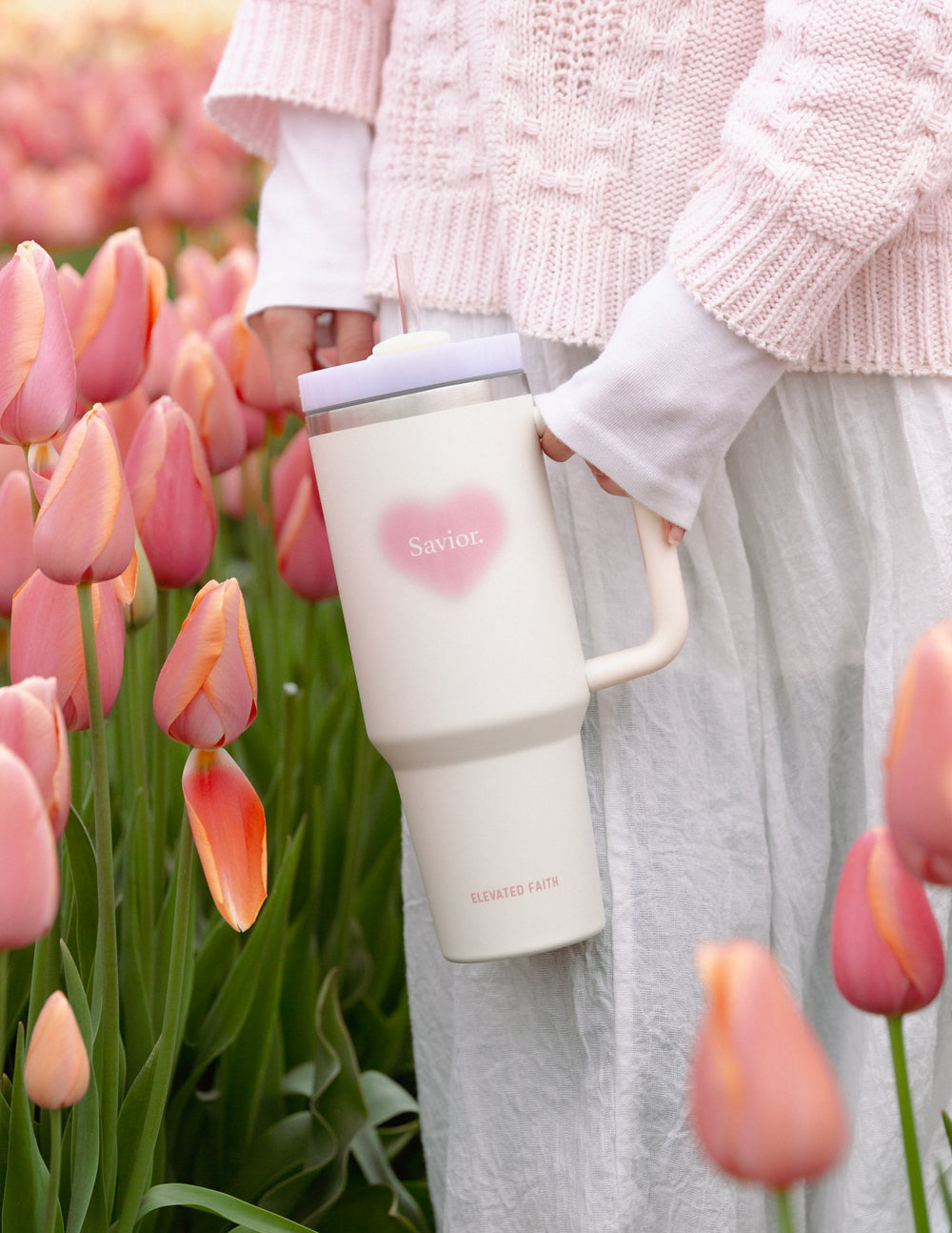 White 40 oz tumbler with pink heart logo, silver lid, and side handle