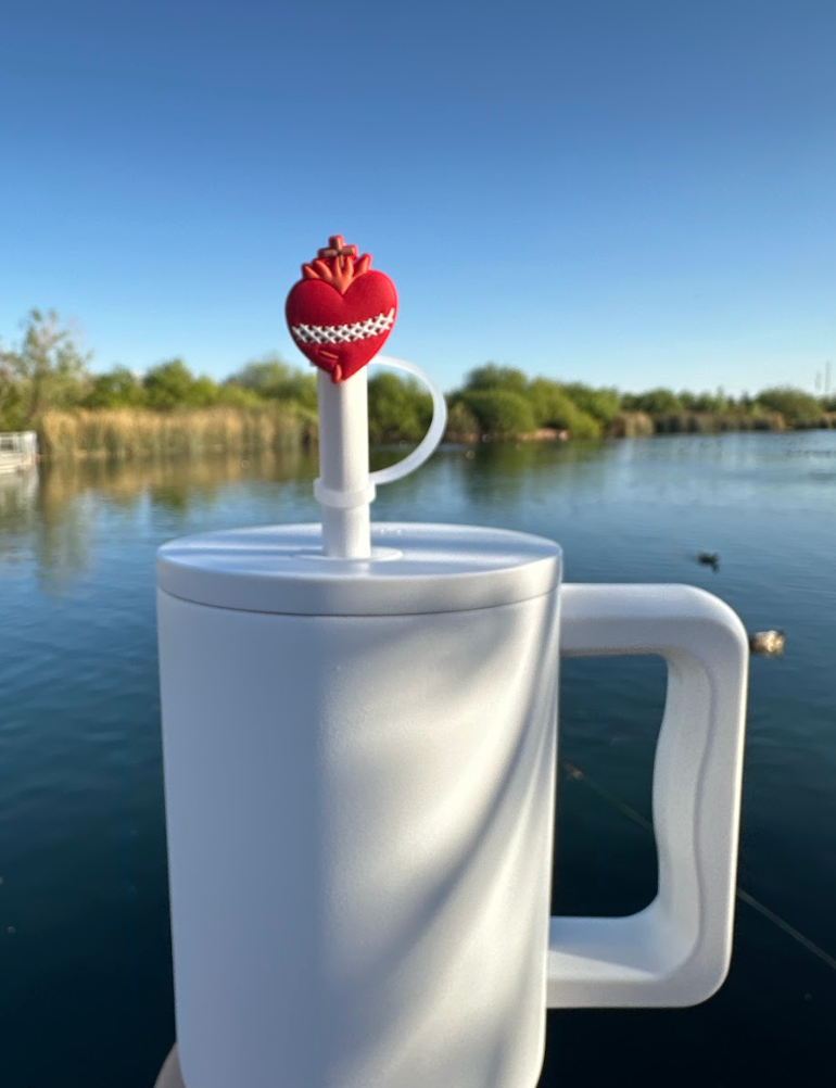 Heart straw topper in red with crown and white loop, mounted on a light drink cup straw