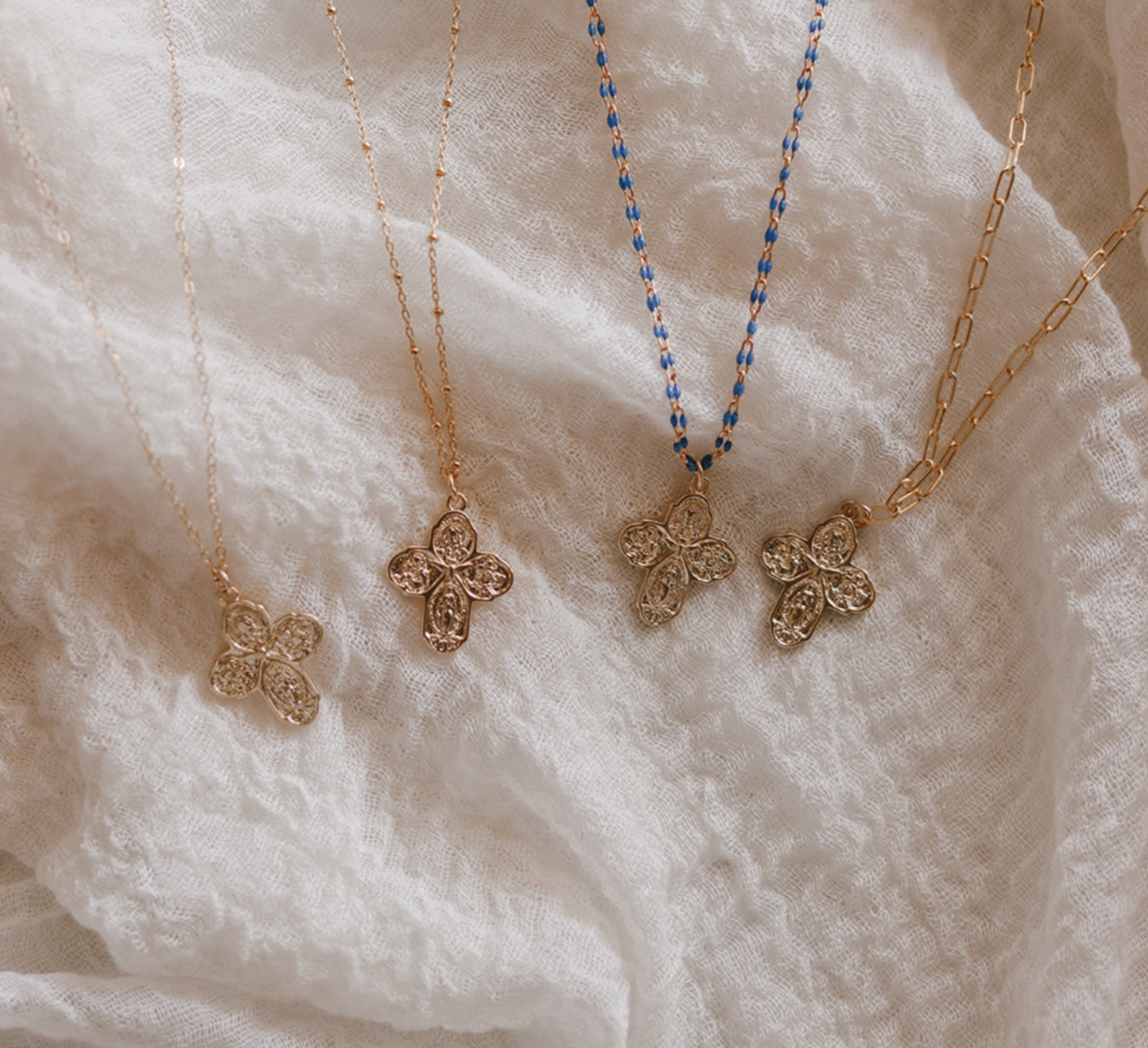 Four cross pendant necklace on paperclip chain, with mixed blue and gold links