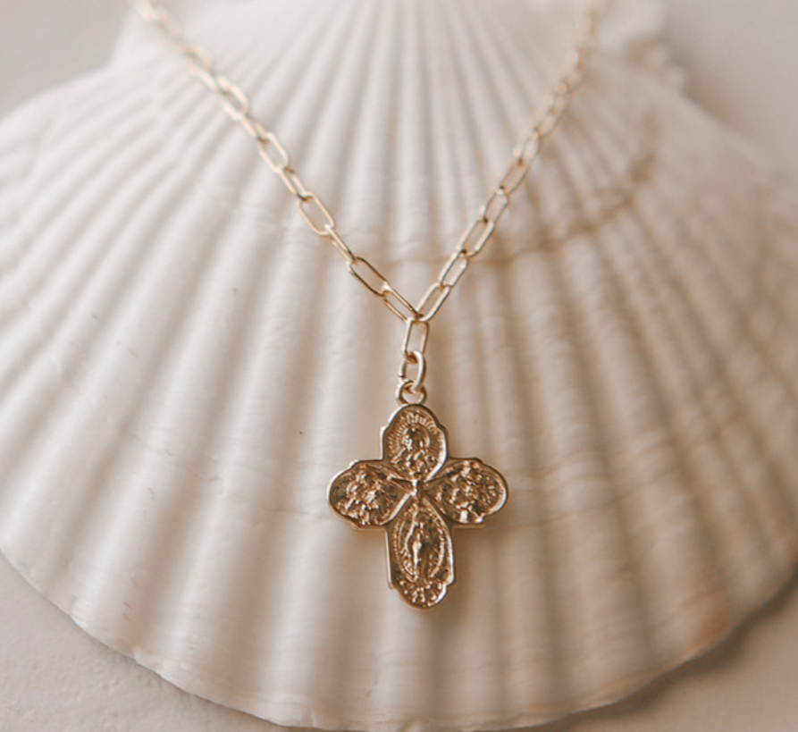 Gold paperclip chain necklace with four-leaf cross pendant, center stud detail