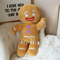 Full-body gingerbread man plush toy with red smile, purple buttons, and white icing laces on pants.