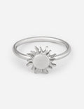 Silver-tone sunburst charm ring with round center and radiating spikes