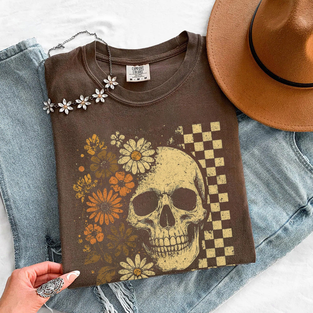 Brown crew-neck t-shirt flat lay with skull and floral checker graphic