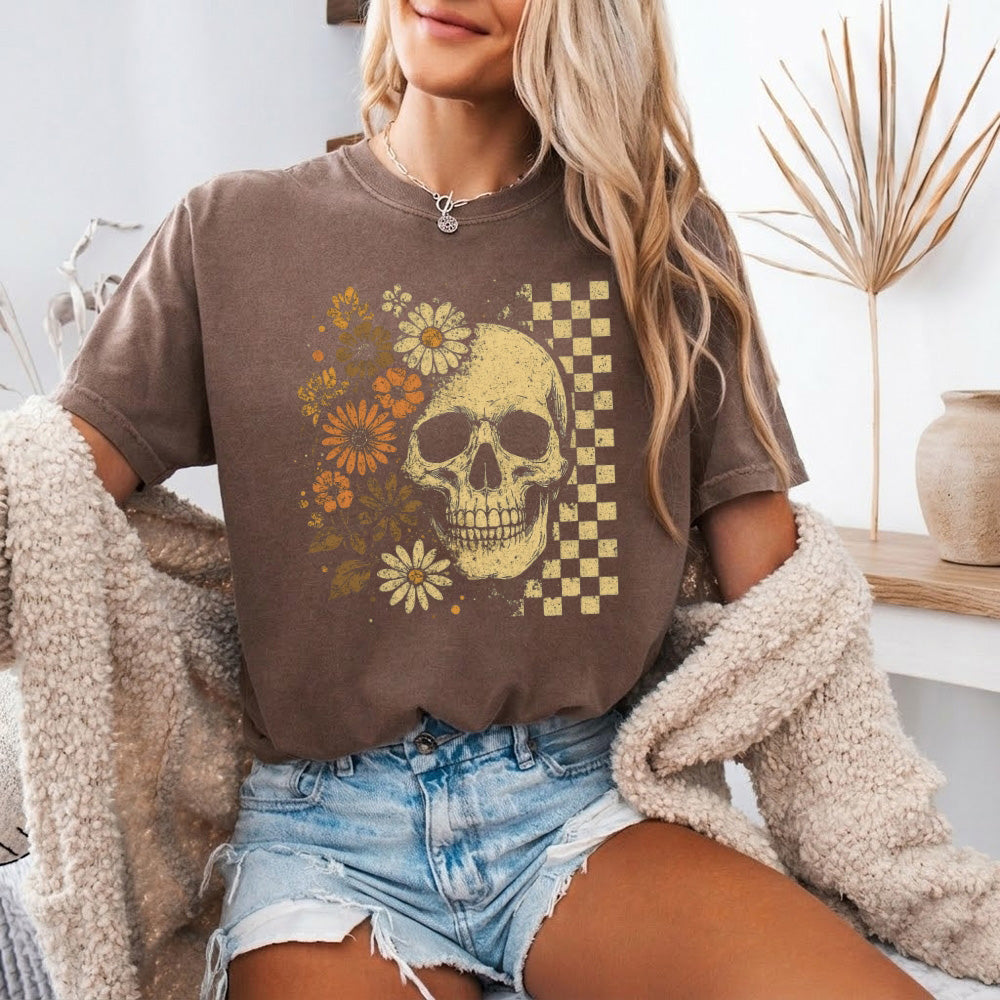 Brown crew-neck t-shirt with skull, flowers, and checker graphic on front