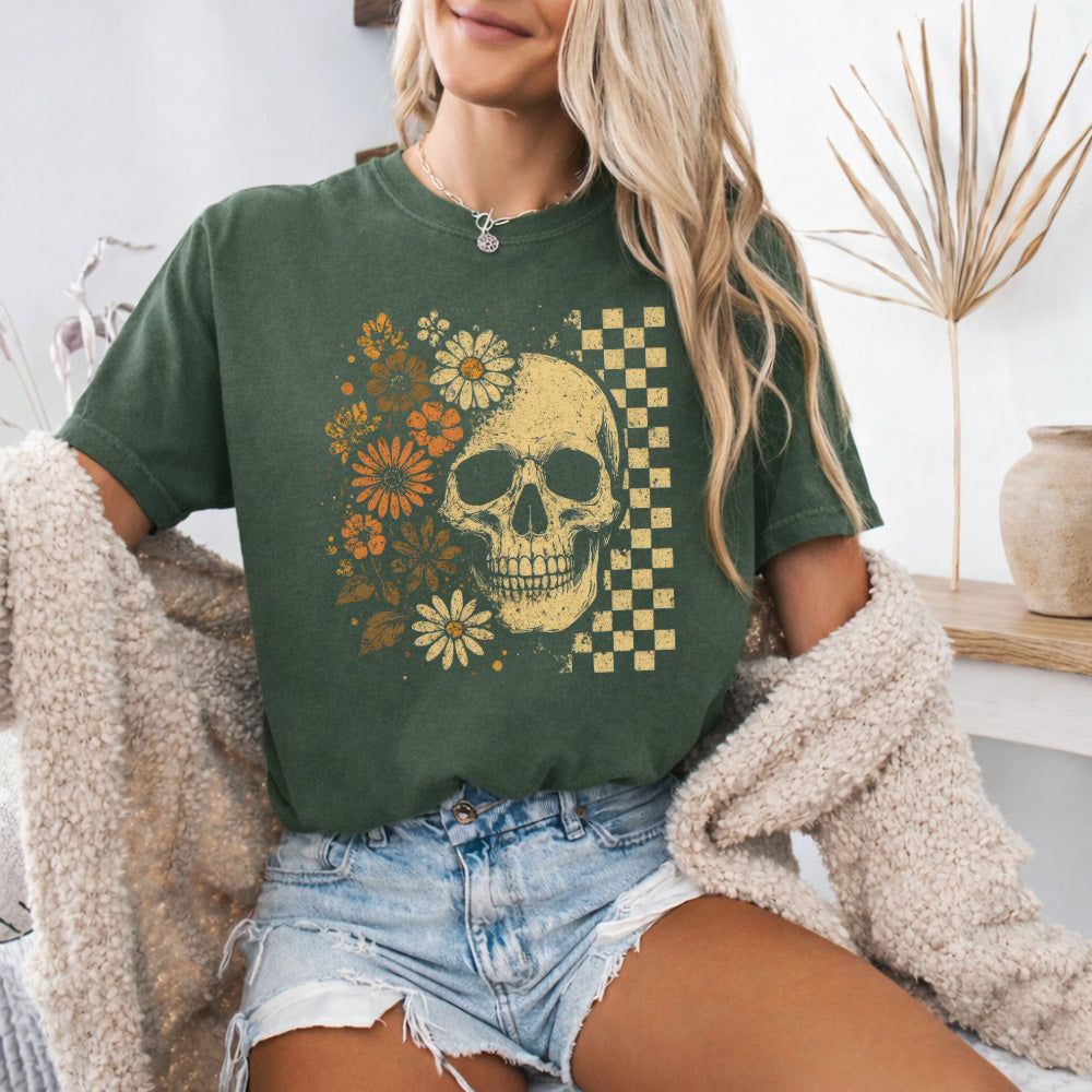 Green crew-neck t-shirt with skull, flowers, and checker graphic on front