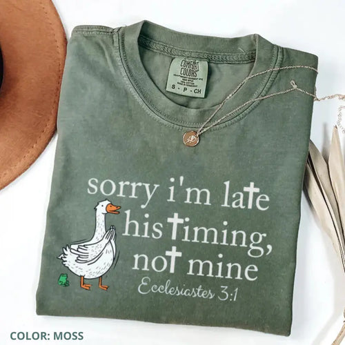 Moss green T-shirt with front goose graphic and Bible verse text, crew neck