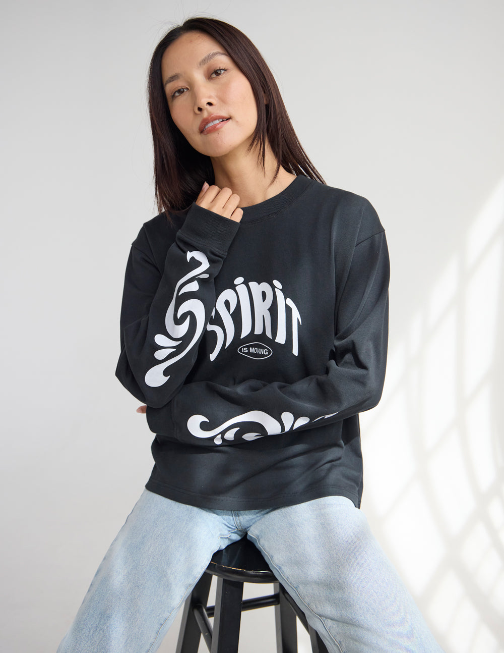 Black long-sleeve heavyweight tee with Spirit front graphic and crew neck.