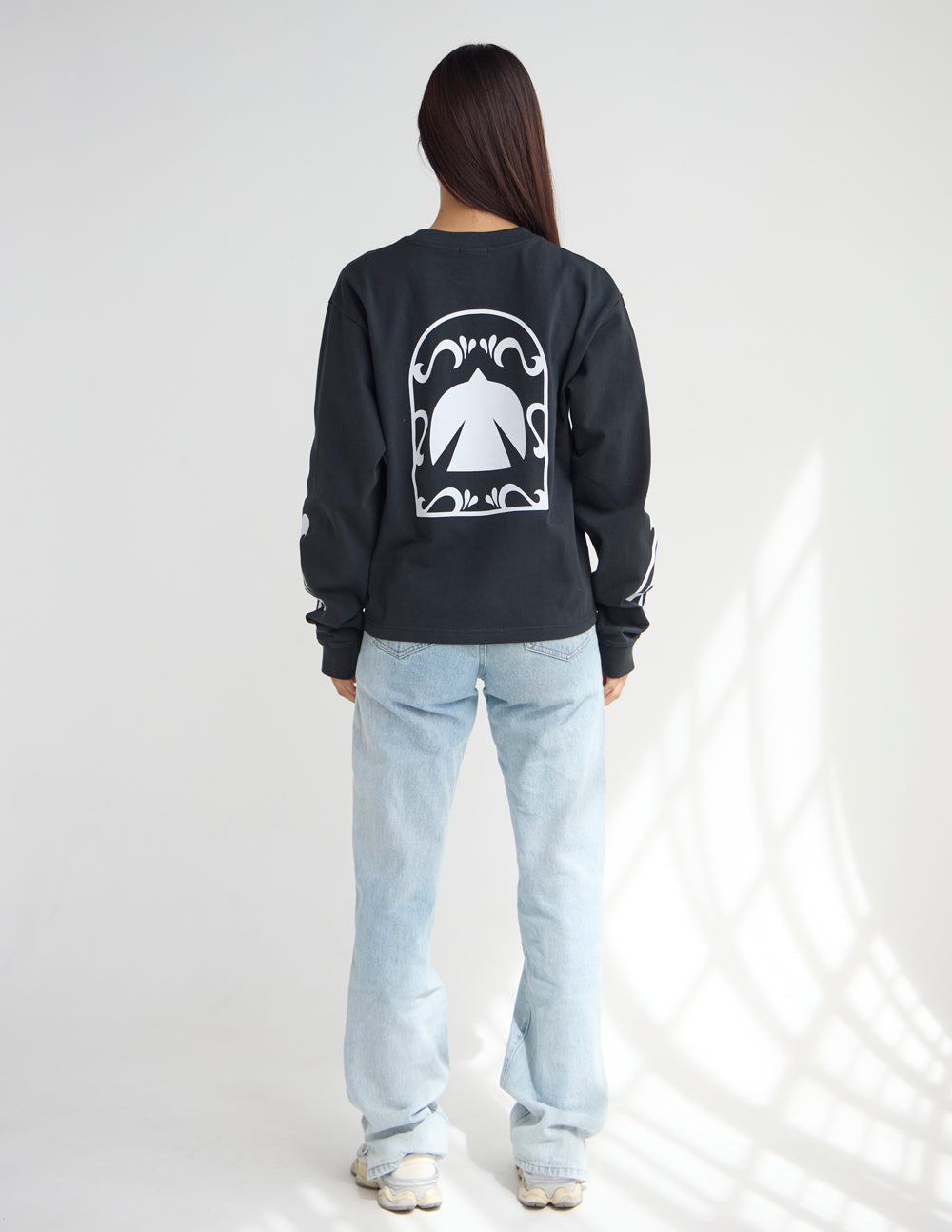 Black long-sleeve heavyweight tee with large back graphic and crew neck.