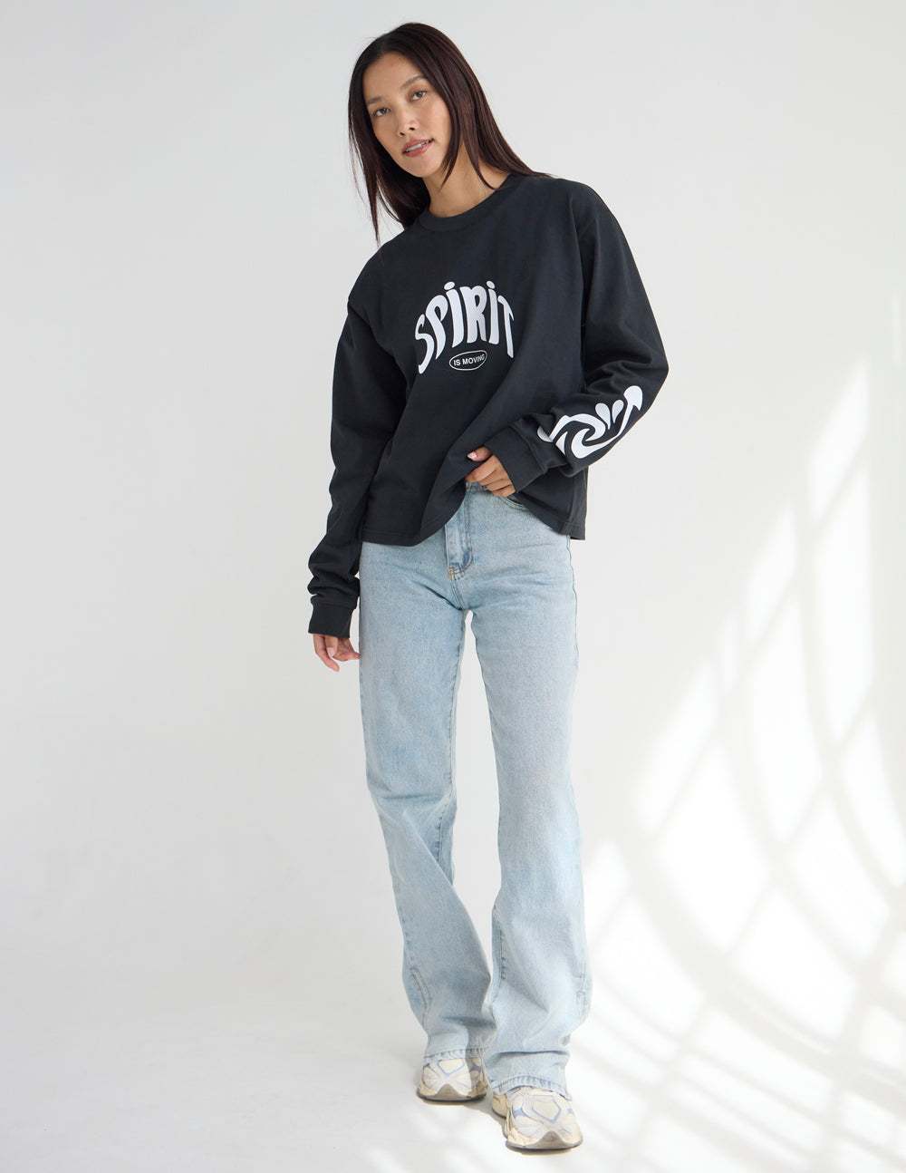 Black long-sleeve heavyweight tee with small Spirit chest logo and printed sleeve cuff.