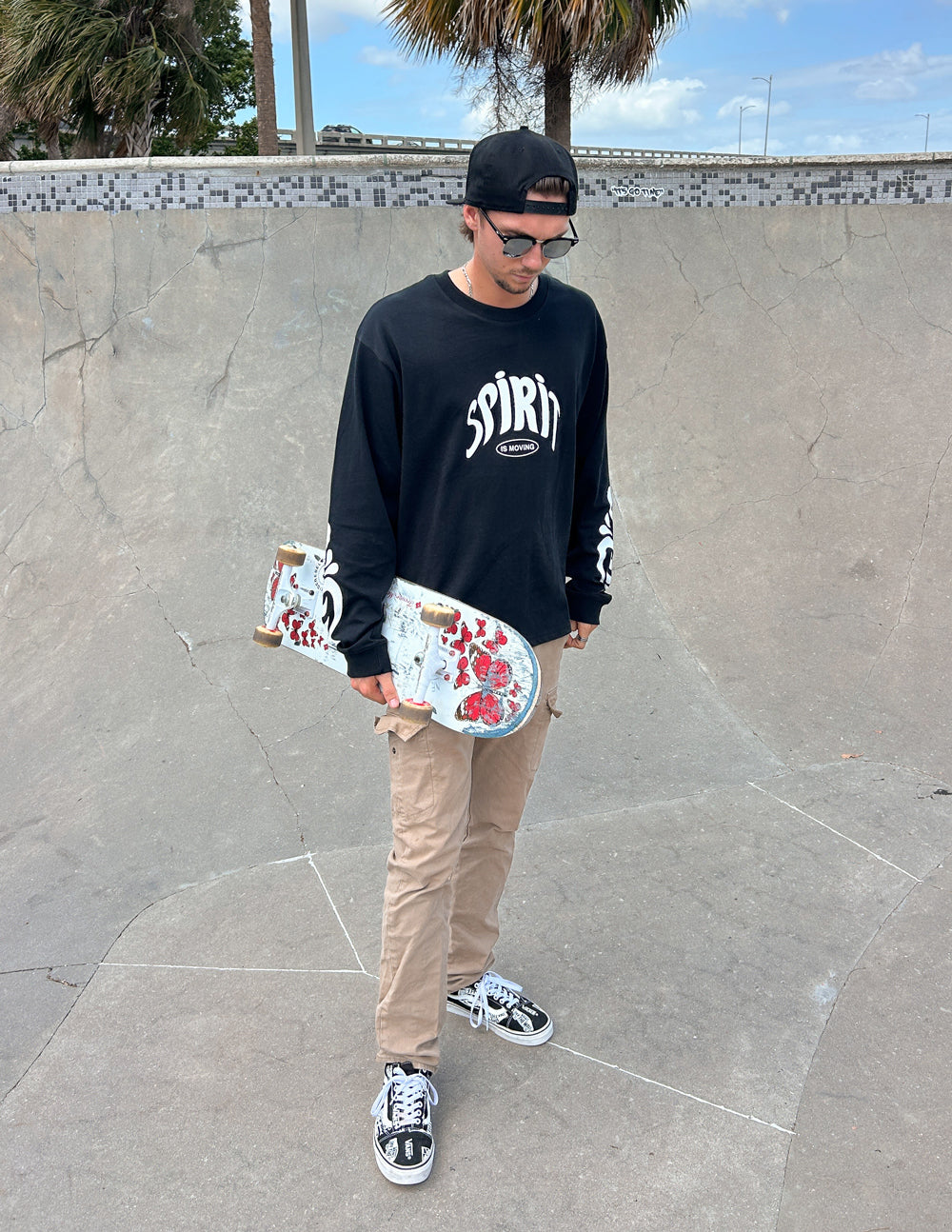 Black long-sleeve heavyweight tee with Spirit chest graphic, worn with long sleeves.