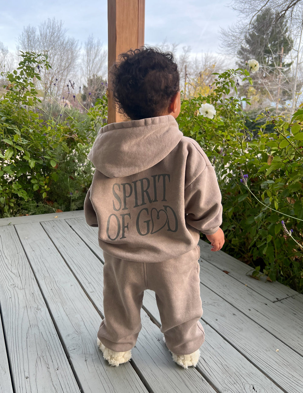 Kids taupe hoodie viewed from behind with hood and “SPIRIT OF GOD” back graphic