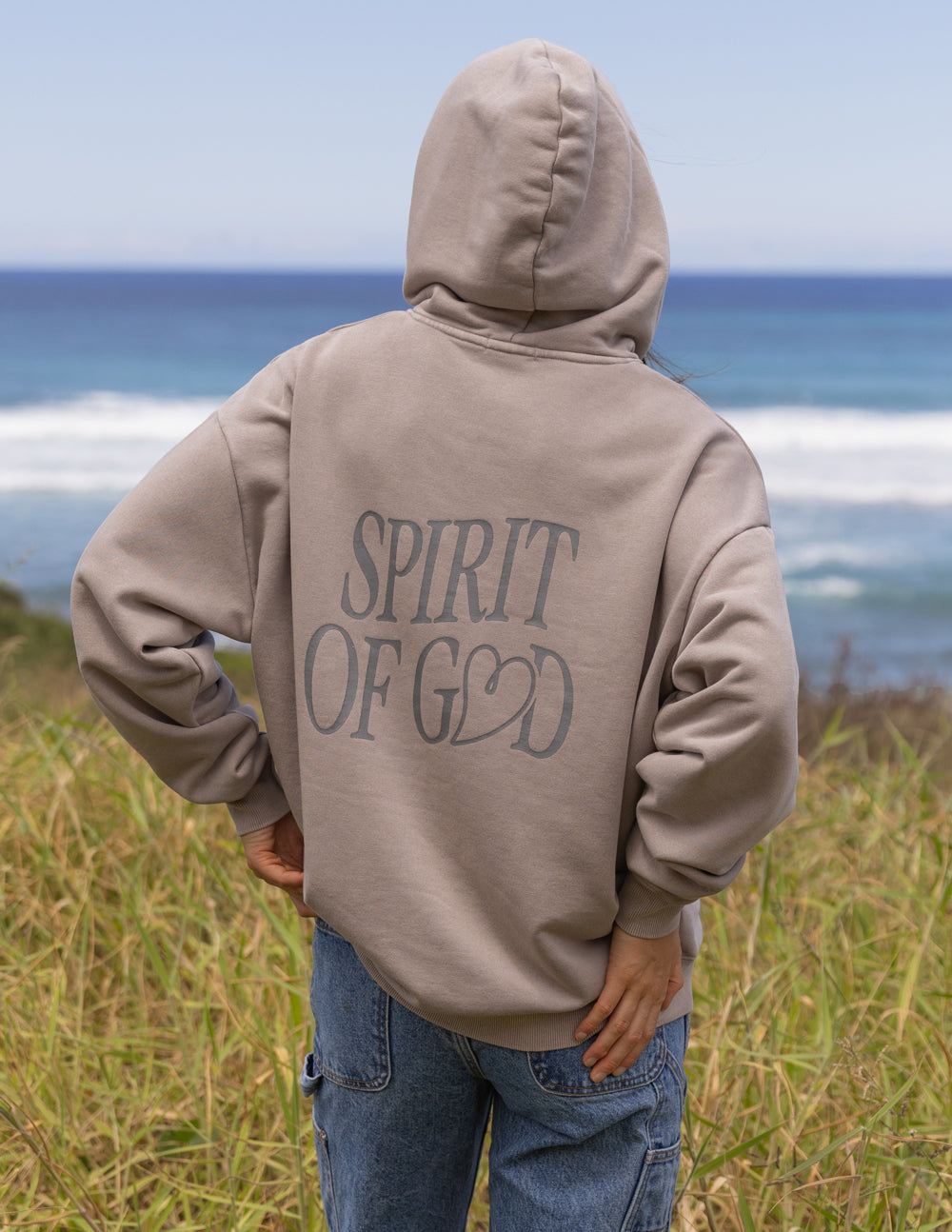 Taupe unisex hoodie back view with 'Spirit of God' graphic and pullover hood